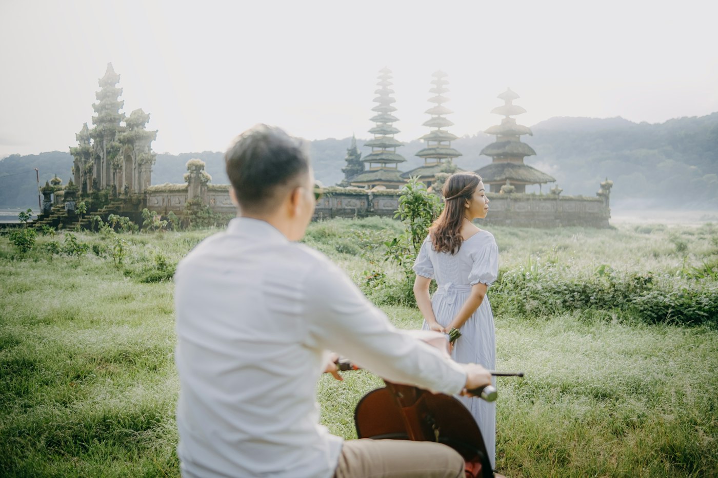 Home A couple riding a bicycle near Lake Tamblingan, Munduk, Bali